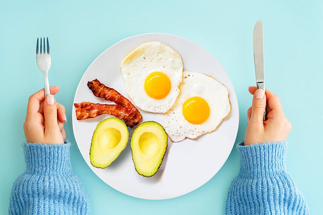 An ideal breakfast in the keto diet menu - eggs with bacon and avocado